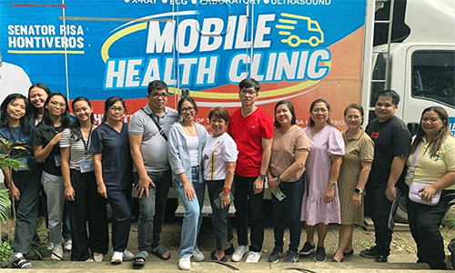 Members of the medical mission team pose in front the Mobile Health Clinic where X-rays and ultrasounds were done during a free health care outreach event at Spottswood Methodist Center in Kidapawan, Philippines, June 21-22. Photo courtesy of Davao Episcopal Area Communications.