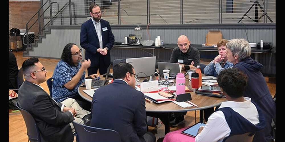 David Scott (standing), senior director of mission theology and strategic planning for the United Methodist Board of Global Ministries, listens to members of the Connectional Table discuss colonialism Oct. 24 during orientation training in Dallas. Photo by Jim Patterson, UM News.