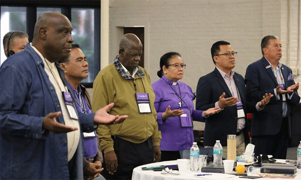United Methodist bishops from the Philippines, Africa and the U.S. pray during morning worship Nov. 6. Photo by Rick Wolcott, Council of Bishops.