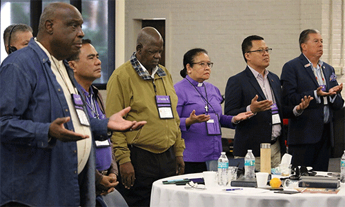 United Methodist bishops from the Philippines, Africa and the U.S. pray during morning worship Nov. 6. Photo by Rick Wolcott, Council of Bishops.