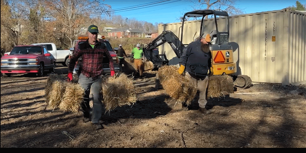 Volunteers delivering hay to victims of Helene as temporary installation for their mobile homes. Video Screengrab.