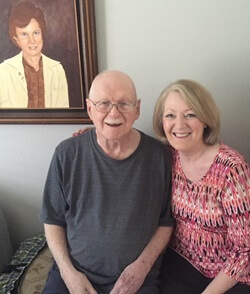 Buchanan visited Joe Quinlan (left) weekly for years until his death. She reflects, “He taught me much about lifelong learning. He was the most curious individual that I’ve ever known. He took up painting following a stroke, as part of his rehabilitation. The picture on the wall is one that he painted of his late wife.” Photo courtesy of Missy Buchanan.
