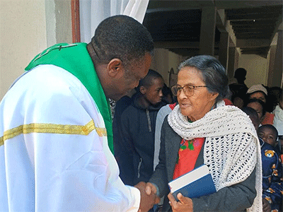 The Rev. Éric Kalumba greets a church member after worship at Ambodifasika United Methodist Church in Ambodifasika, Madagascar. Kalumba, a missionary with the United Methodist Board of Global Ministries, is charged with planting new United Methodist churches across the island. Photo by Esdras Rakotoarivony, UM News.