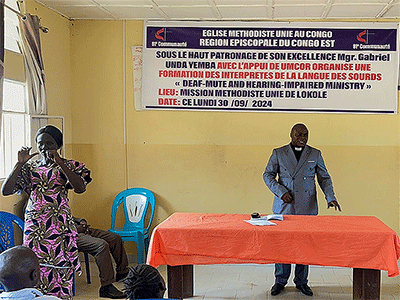A member of Lokole United Methodist Mission in Kindu offers sign language interpretation during worship, helping make the service more inclusive. Photo by Chadrack Londe.