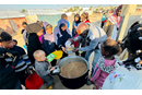 Hana's* family arrives at the camp gathering point for a hot, cooked meal. (Photo: IOCC) *names have been change Hana's* family arrives at the camp gathering point for a hot, cooked meal. (Photo: IOCC) *names have been change