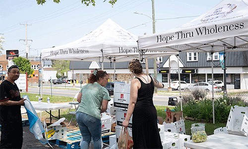 Spring sun shined warmly on a crowded parking lot as neighbors from near and far gathered at the parking lot of Prospect UMC for a free farmers market and resource fair.