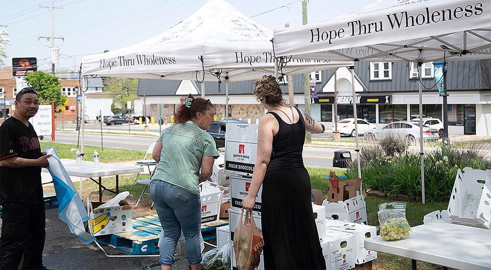 Spring sun shined warmly on a crowded parking lot as neighbors from near and far gathered at the parking lot of Prospect UMC for a free farmers market and resource fair.