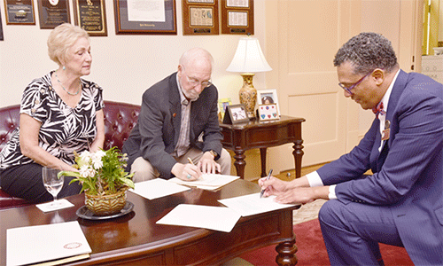 Rev. Robert Gibbs signs paperwork for Major Gift. This gift will create Scholarship Funding for Ministry Students, Highlights Important Role of Clergy in Supporting the Next Generation of Leaders. Courtesy photo.