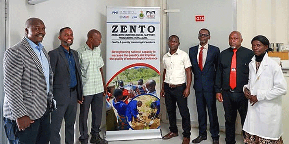 Staff with the Zimbabwe Entomological Support Program in Malaria stand inside the insectary at Africa University in Mutare, Zimbabwe, during a rededication of its research lab on Aug. 27. The program was shut down earlier this year after funding from USAID was suspended. From left are Sungano Mharakurwa, Vuyisile Mthokozisi Mathe, Joseph Makanda, Fanuel Toto, Hieronymo Masendu, Petros Kawadza and Violla Chimwayi. Photo by Ben Smith, UM News