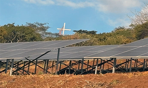 The massive renewable energy plant built below the Africa University Cross and Flame in Mutare, Zimbabwe, includes 576 panels producing enough energy to power 600 households. The solar project is the first and largest in Manicaland province where the school is located. Photo by Eveline Chikwanah, UM News.