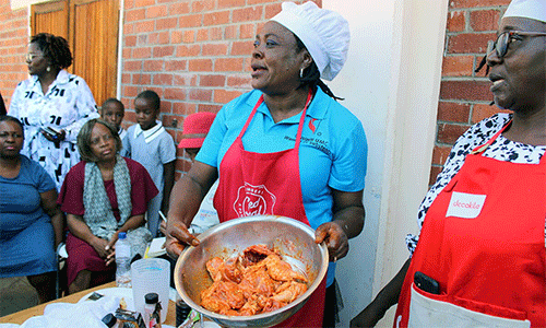 Sandra Kudzika (center) and Franscisca Madondo teach Women of Substance members to prepare relish and bake buns during cooking classes. Photo by Kudzai Chingwe, UM News.