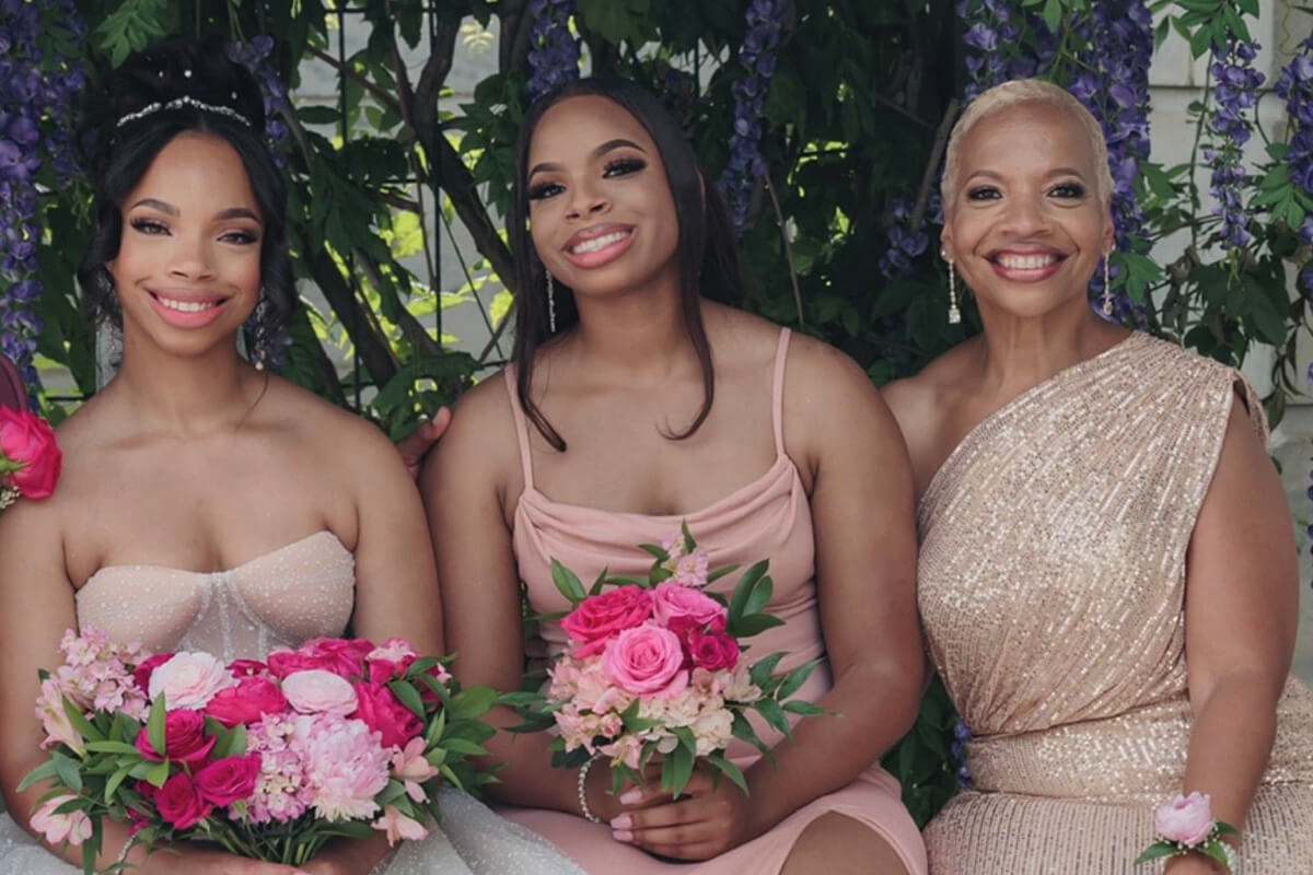 Bishop Tracy S. Malone (far right) celebrates her oldest daughter’s wedding in 2023. From left are bride Alexis Malone Woolery and her sister, Ashley Malone Brown. Bishop Malone’s daughters say they have something special planned this year on Mother’s Day, since the day coincides with Woolery’s graduation and Woolery is the mother of a 1-year-old son. Photo by Sekoprince Studios. 