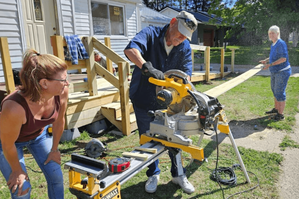 A volunteer team from Walled Lake UMC serves at God’s Country Community Ministries by building a ramp to make the homeowner’s house accessible. This United Methodist ministry serves the rural population of the eastern Upper Peninsula in Michigan, and is directed by Randy Hildebrant, a Church and Community Worker. Photo courtesy God’s Country Community Ministries and the Michigan Conference.