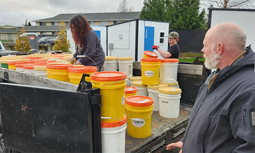 Volunteers from Skagit County loading up cleaning kits from the First UMC Mount Vernon relief supply storage center. Photograph by Rev. Christopher Gudger-Raines.