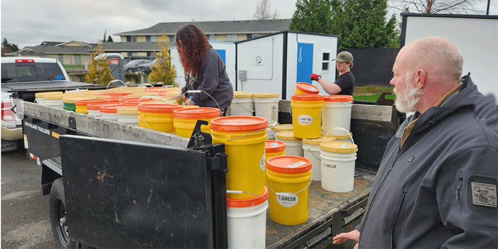 Volunteers from Skagit County loading up cleaning kits from the First UMC Mount Vernon relief supply storage center. Photograph by Rev. Christopher Gudger-Raines.