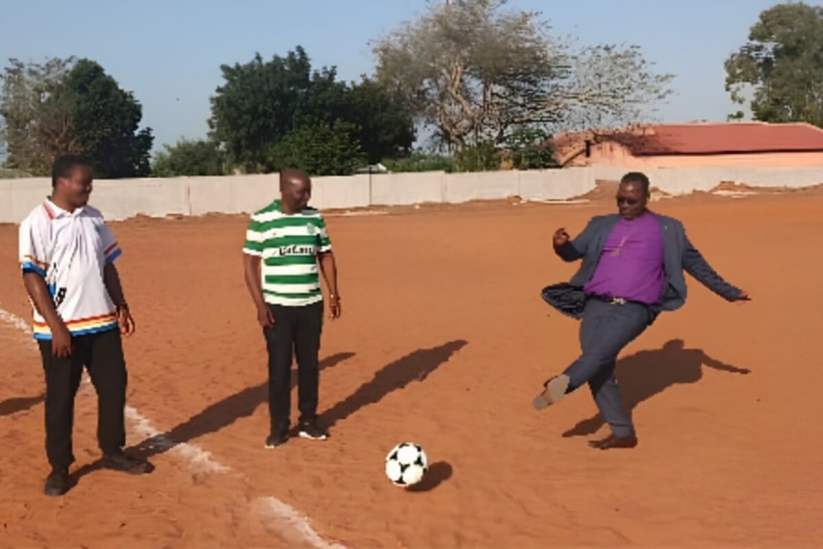Bishop João Filimone Sambo delivers the ceremonial first kick of the "Lives in Christ Cup," an Evangelism Through Sports ministry that brings together church leaders, government officials, and the community to help prevent youth involvement in crime in Marracuene, Maputo. Photo by Naftal Guambe.