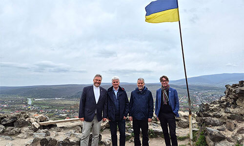  (From left) Bishop Werner Philipp, local preacher István Pásztor from Hungary, Bishop Stefan Zürcher and Bishop Knut Refsdal stand under a Ukrainian flag at Nevytske Castle, north of Uzhhorod, during their visit to Ukraine on March 26-30. The bishops’ trip was intended as a sign of solidarity and a reminder to people in Ukraine that they have not been forgotten. Photo courtesy of EmK-Öffentlichkeitsarbeit Germany, UM News.