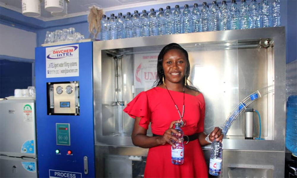 Project Manager Tabitha Waithira, of Trinity UMC in Naivasha, Kenya, demonstrates the water filling station and filtration system funded by an UMCOR grant. Photo: Kudzai Chingwe.